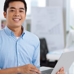 A fresh graduate searching for available jobs in his laptop