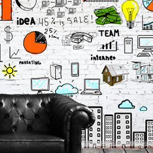 Informative white wall in the office filled with icons for creativity and ideas