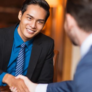 Employee shakes hands with his boss to celebrate the promotion